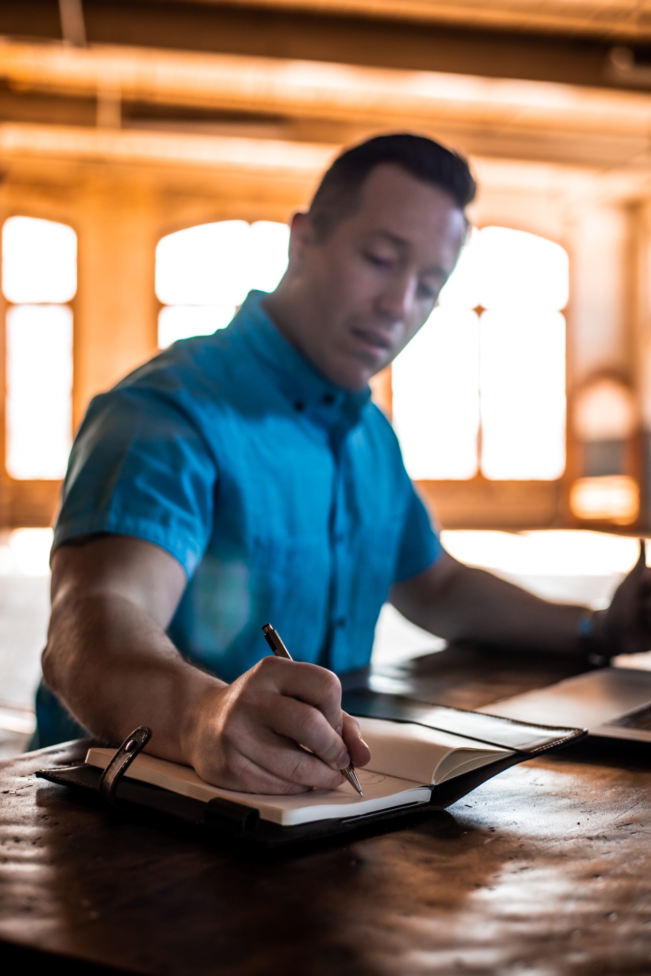 Matthew Peck writing in a journal